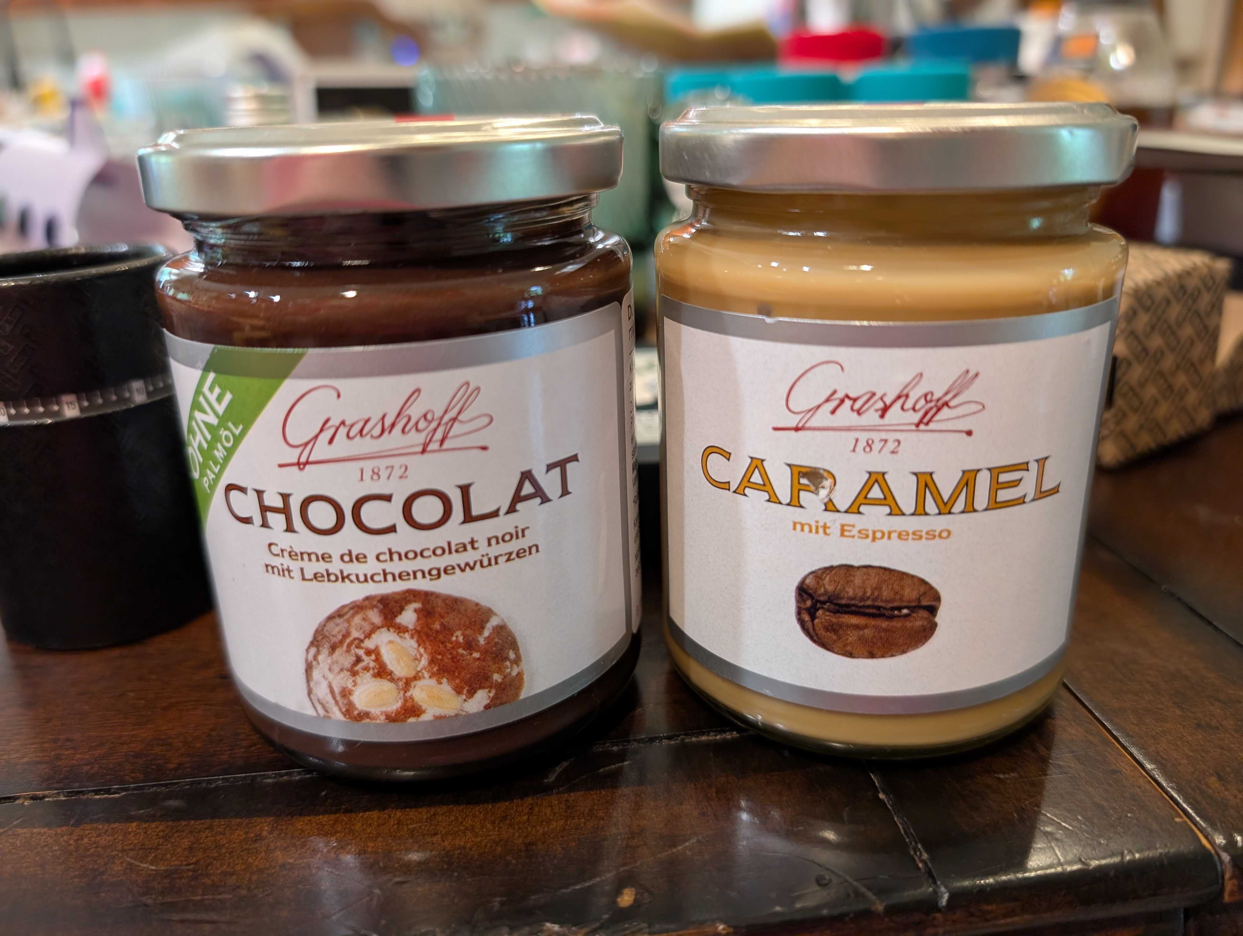 Two jars of sweet spreads: caramel with espresso and chocolate with lebkuchen spices