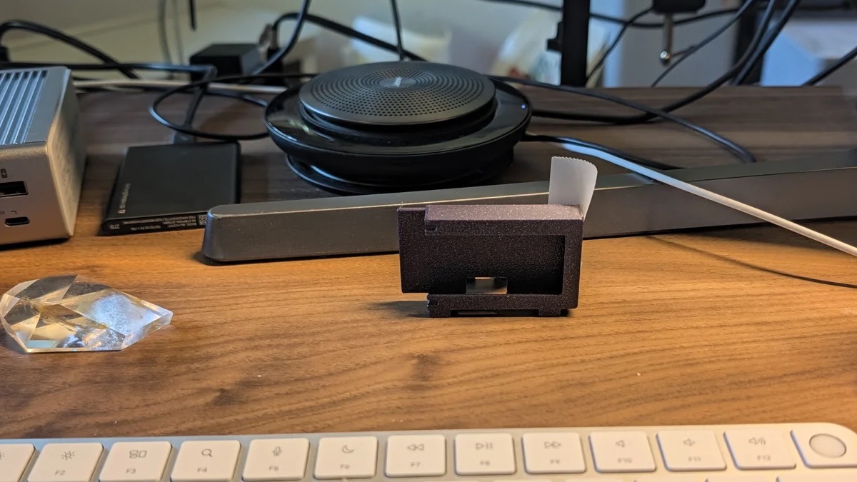 First printed enclosure propped beneath the monitor from the seated viewing position