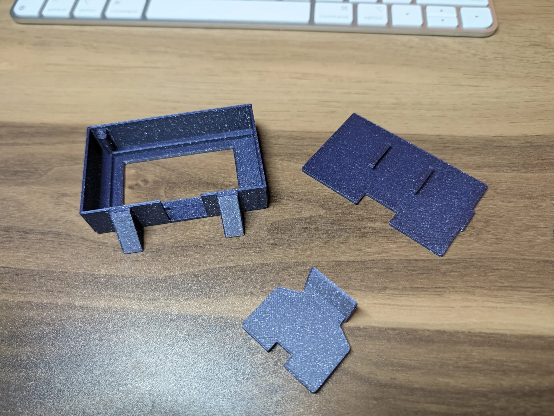 The three completed V3 enclosure parts arranged on the desk