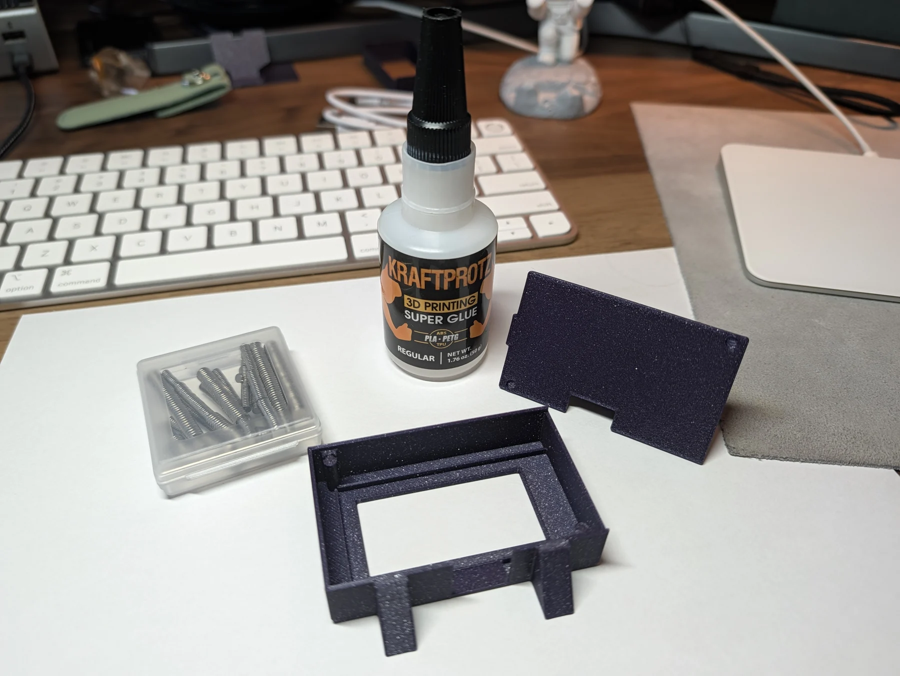 V3 frame, magnets, and cyanoacrylate glue arranged for installation