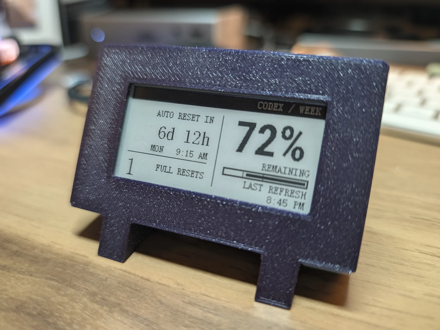 Finished powered purple e-paper display photographed from three quarters